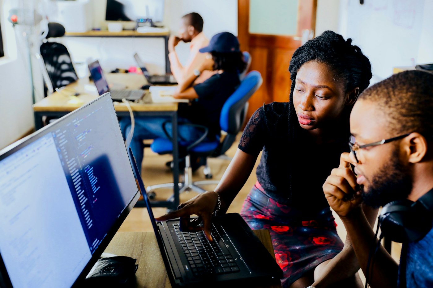 Two colleagues reviewing business data on screen